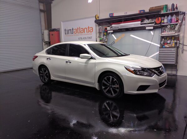 White Nissan Altima sedan with window tint installation tintsaltlake