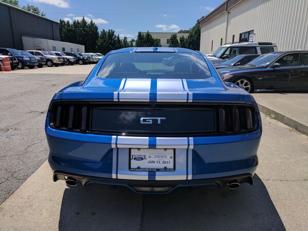 Blue Ford Mustang GT with racing stripes and tinted windows Salt Lake City